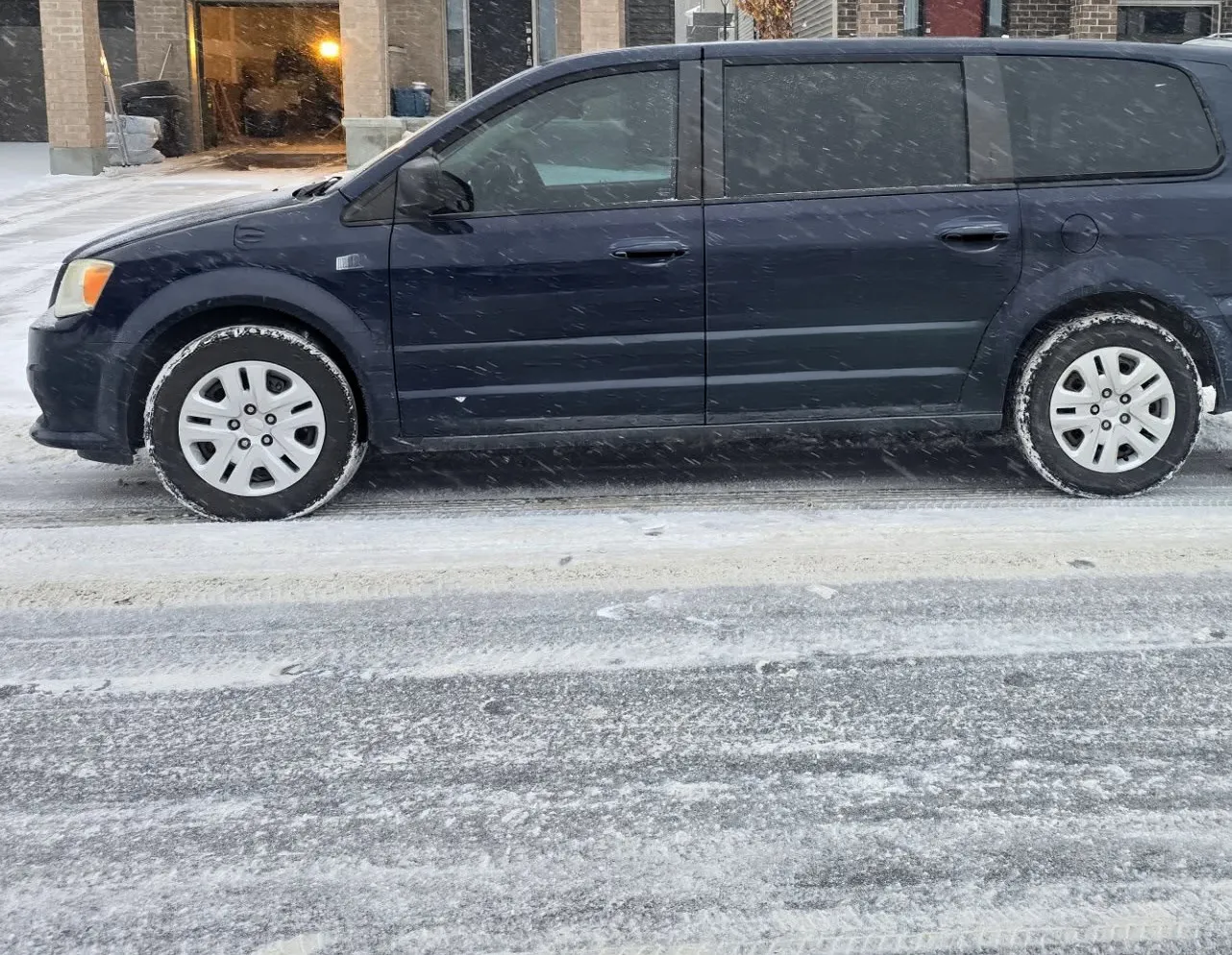 Navy minivan with bare panels before the graphics were applied