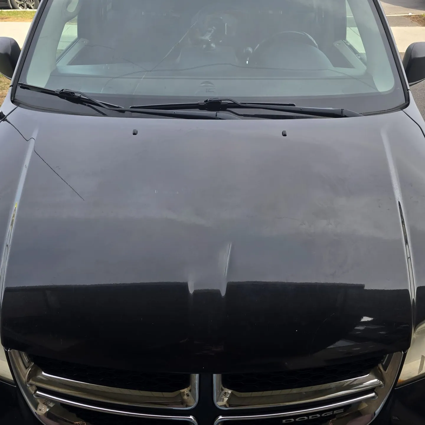 Bare black minivan hood before the decal was applied