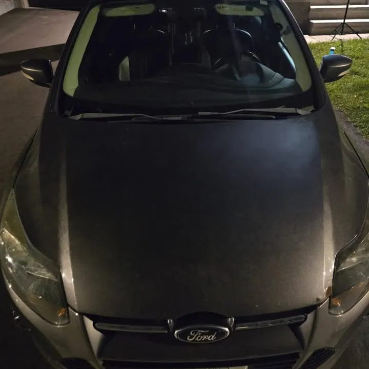 Bare grey sedan hood before the decal was applied