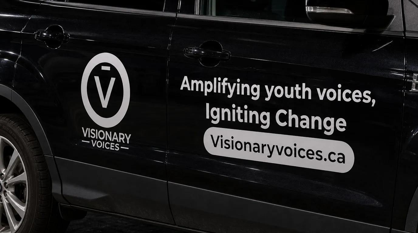 Close view of white cut vinyl lettering and a web address decal on a black door